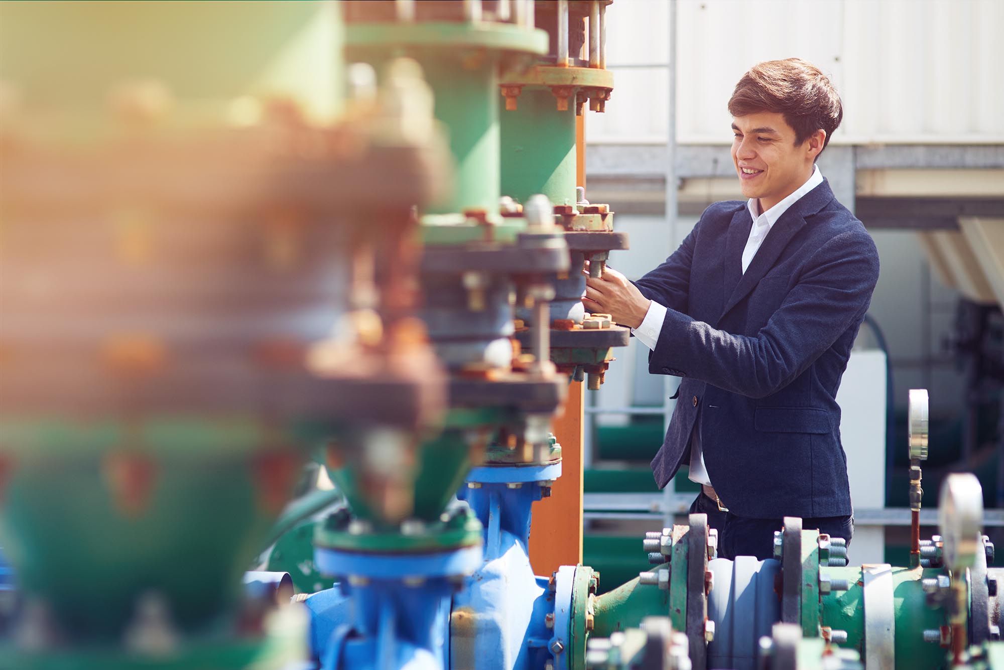 It is in order. Cheerful diligent engineer trainee smiling whille checking the pipeline